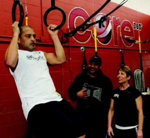 World champion Jose Miguel Cotto works out in the Team Abdallah training camp at the Lockport Athletic & Fitness Club with head coach Juan Deleon, center, and LA&FC strength and conditioning coach Gina Nowak looking on.