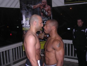 Lockport’s Amer Abdallah, left, and Jerald “The Gettoblaster” Johnson of Milwaukee exchanged unpleasantries during Friday night’s official weigh-in at Finnan’s Bar & Grill on Lincoln Avenue. Heavyweights Abdallah and Johnson are the main event tonight in a 13-fight kickboxing card at the Kenan Center Arena. STEPHEN WALLACE/CONTRIBUTOR